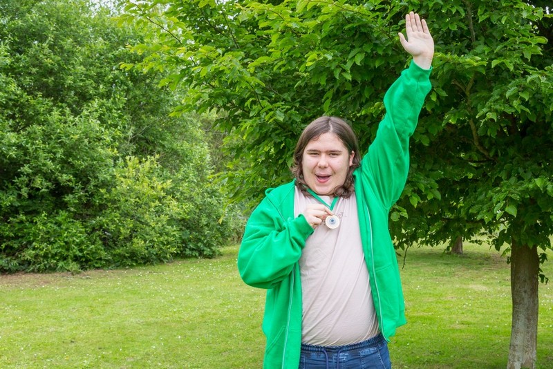 Picture of a young man holding his medal masonic fishing charity